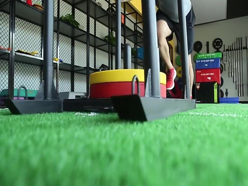 High-performance gym turf for sled training